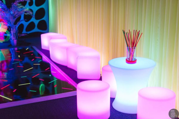 glow themed event with glow cocktail table and glow cylinder seats