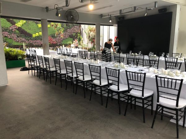wedding reception with white tables and black tiffany chair