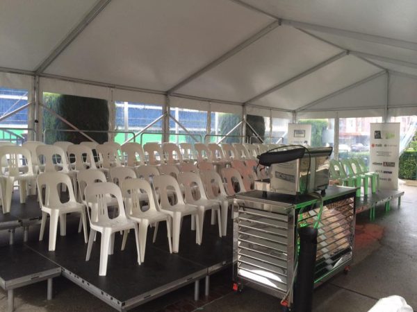 white plastic chairs on a stage for a school event 
