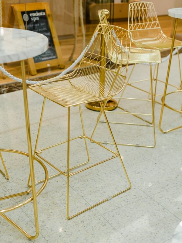 gold wire stool with gold arrow cocktail table with white marble top