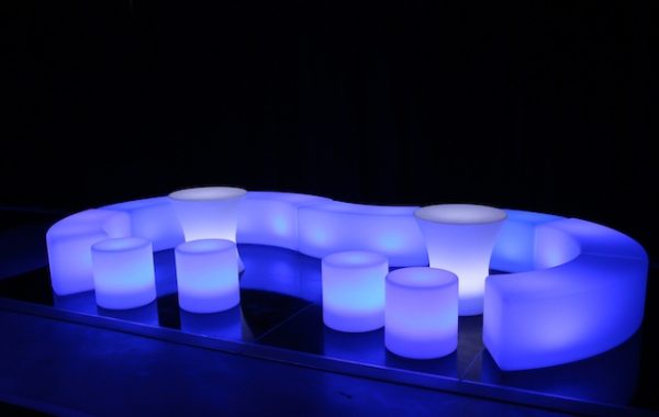 glow themed event with glow cylinder seats and curved benches