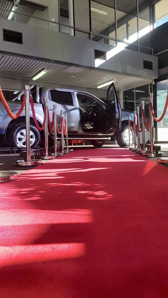 red carpet with chrome bollards and red rope for a car exhibition