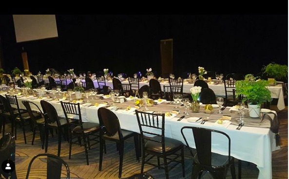 a function with black tiffany chairs, victorian chairs and tolix chairs