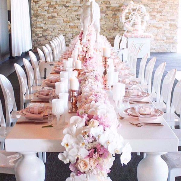 engagement party set up with white victorian chair with white and pink floral decorations