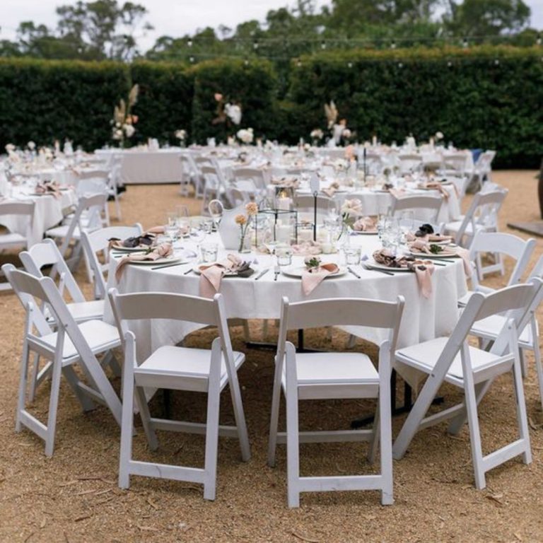white padded folding chair for a wedding reception outdoor event