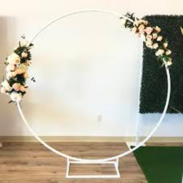 white hoop backdrop with white and pink floral decorations