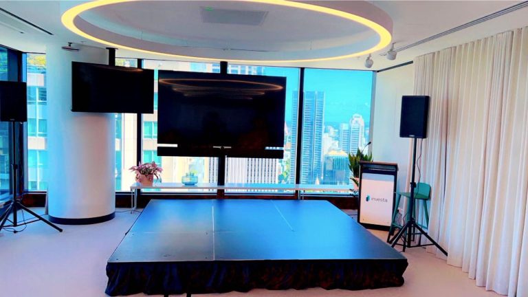 tv, stage and speaker and lectern set up for business event