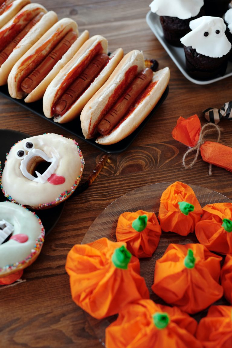 halloween themed food like donuts, hotdogs and cupcakes